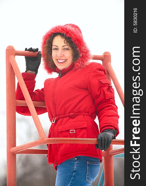 A pretty woman on metallic ladder in winter