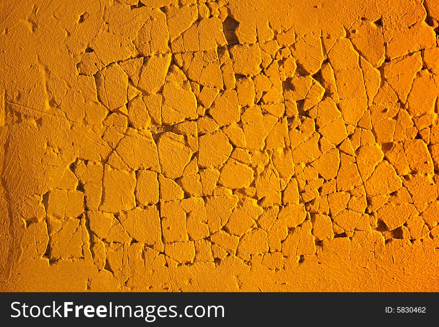 Close-up of orange eroded plaster