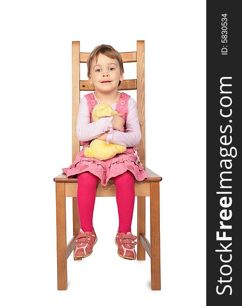 Little girl with toy sitting on stool