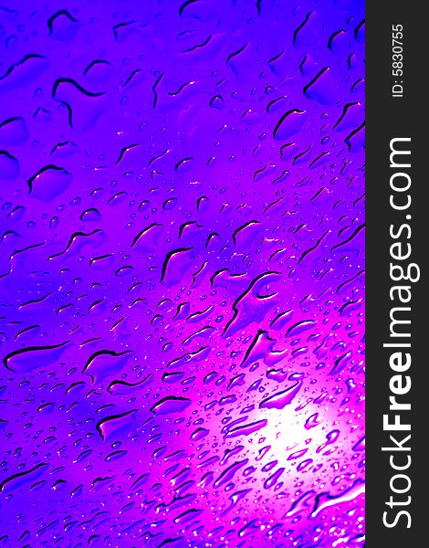 After a heavy rain the water drops on the car sunroof appear like colourful diamonds.