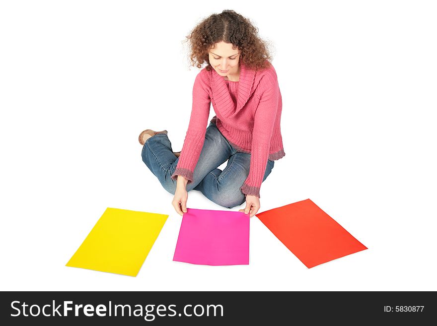 Young woman sits on floor with three multi-coloure