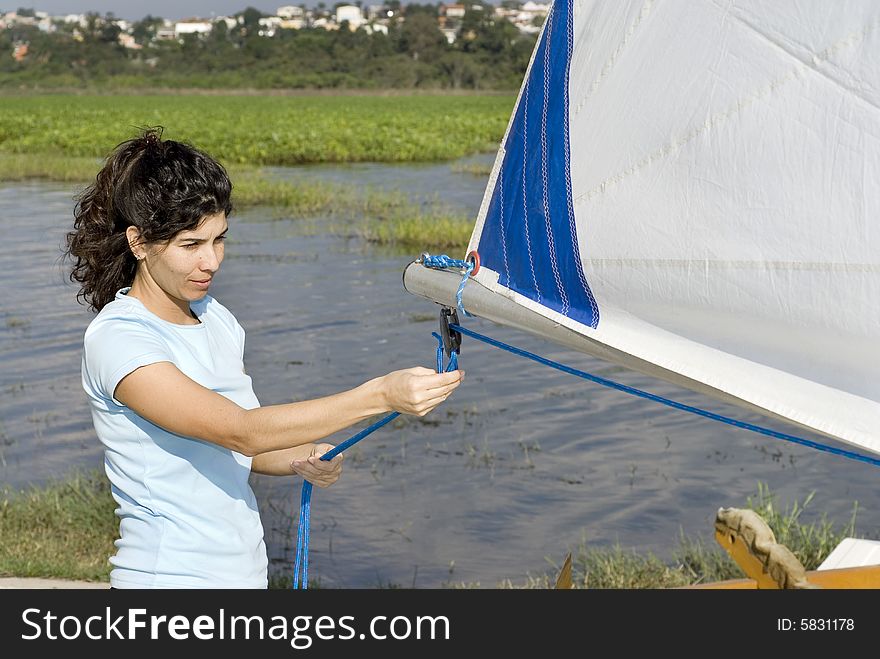 Woman Fixing Ropes on Sailboat - Horizontal