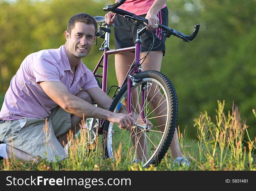 Man Fixing a Bike - Horizontal