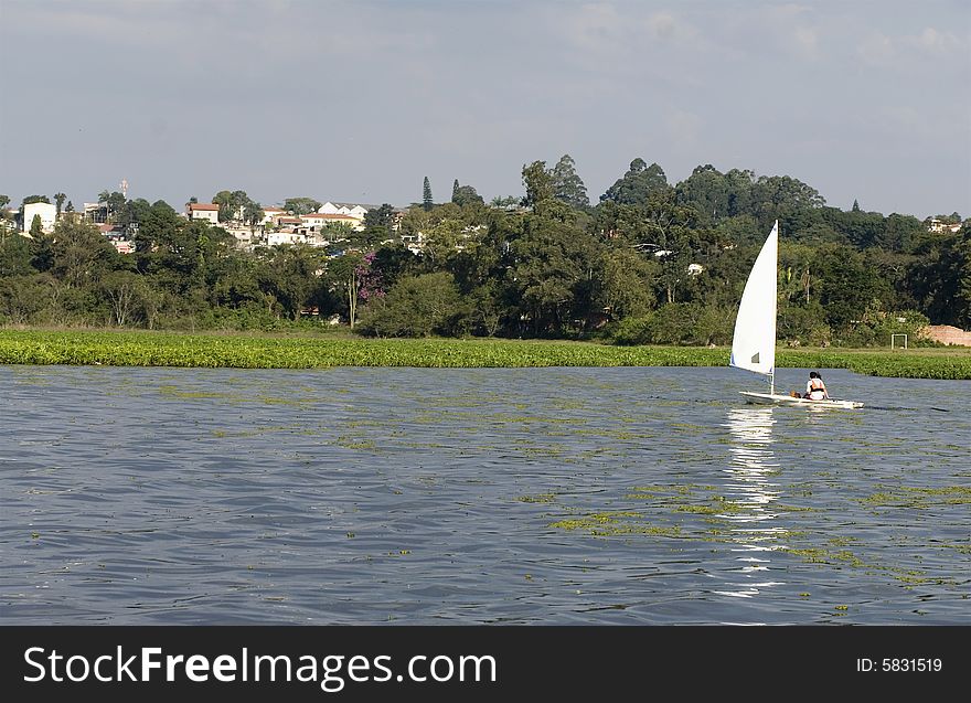 Man And Woman Sailing In Sailboat - Horizontal