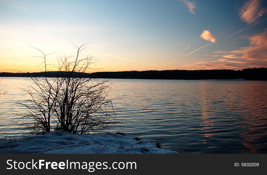 Sunset,silent dam,winter surface,