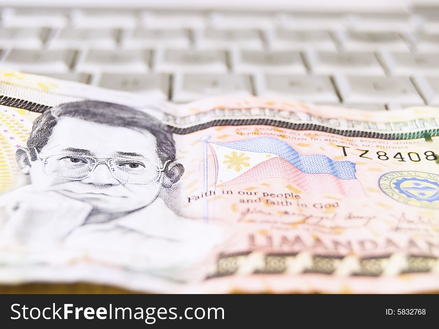 Philippine money on computer keyboard