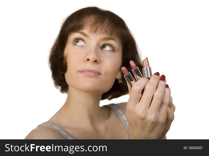 A photo of a young woman choosing a lipstick