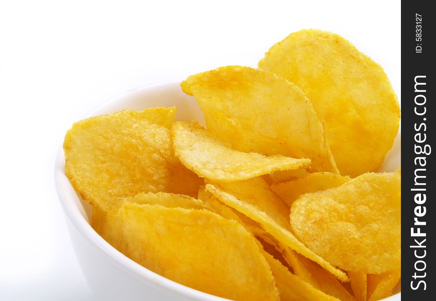 Yummy potato chips in white bowl. Yummy potato chips in white bowl