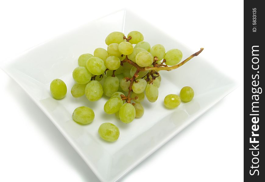 Fresh bunch of green grapes in white bowl and isolated on white background. Fresh bunch of green grapes in white bowl and isolated on white background