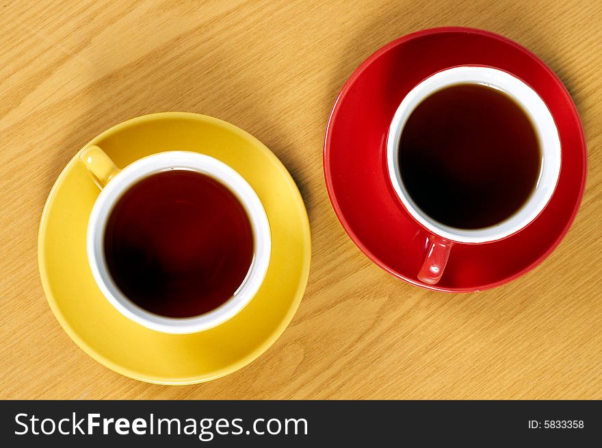 Two cups of tea on wooden background