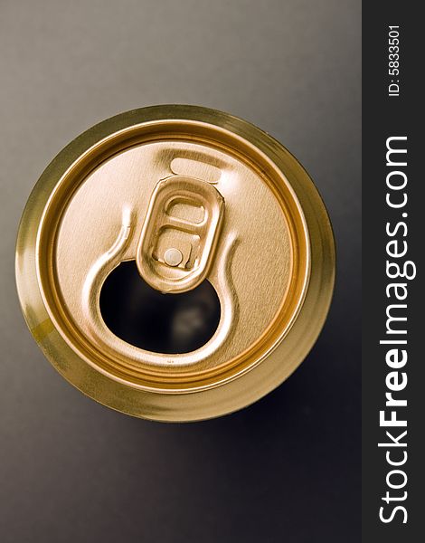 Aluminum  can of gold color costs on a grey background