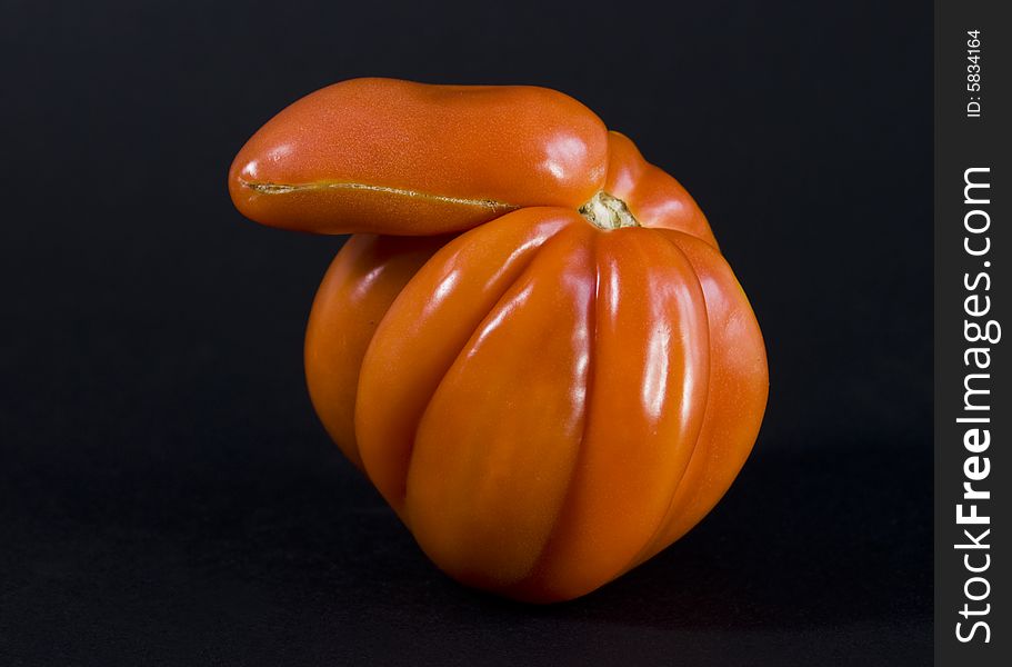 Strange form tomato isolated on black background. Strange form tomato isolated on black background