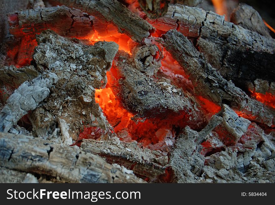 Burning coal in hot campfire flame