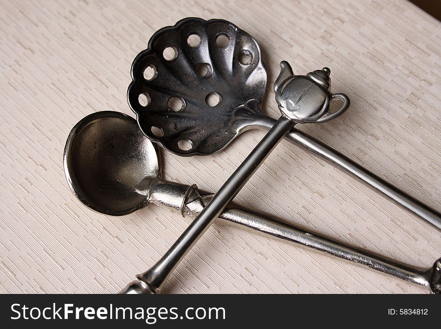 Silver spoons on a cream coloured box background. Silver spoons on a cream coloured box background