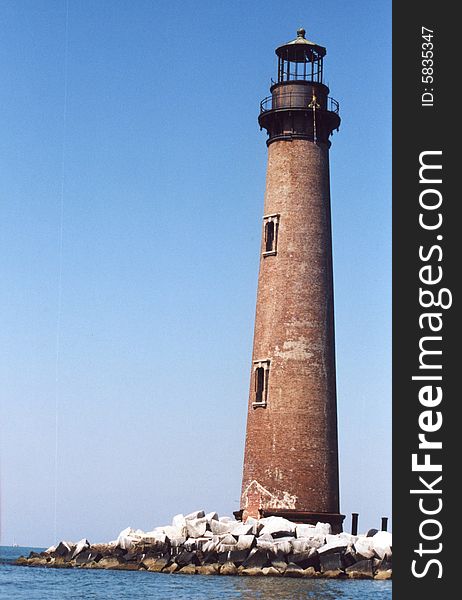 Photo of a tall brick and iron lighthouse.