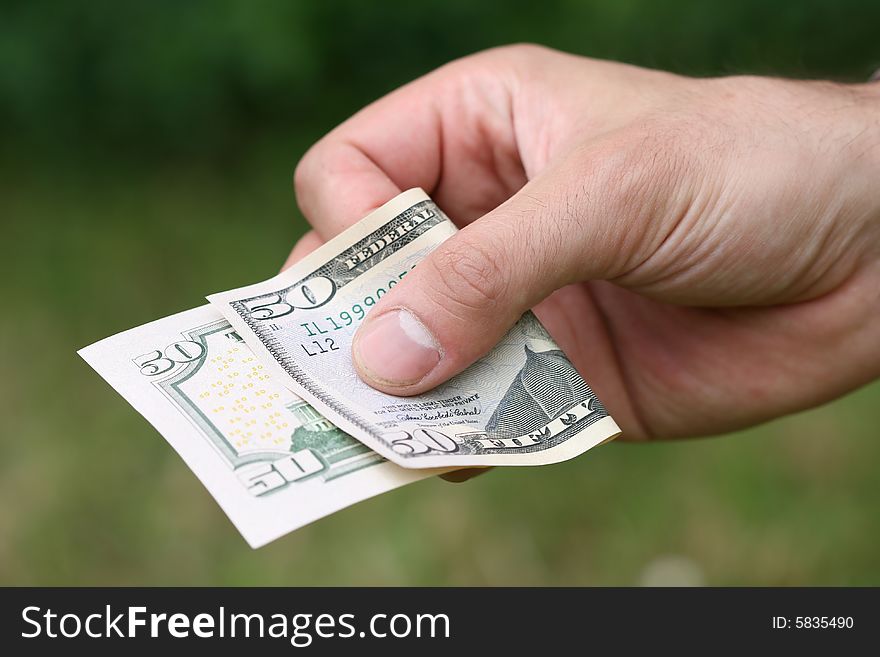 ManÂ´s hand with fifty dollars. ManÂ´s hand with fifty dollars