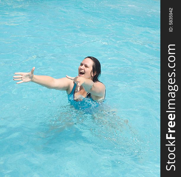 Woman in the water merrily extend hands. Woman in the water merrily extend hands