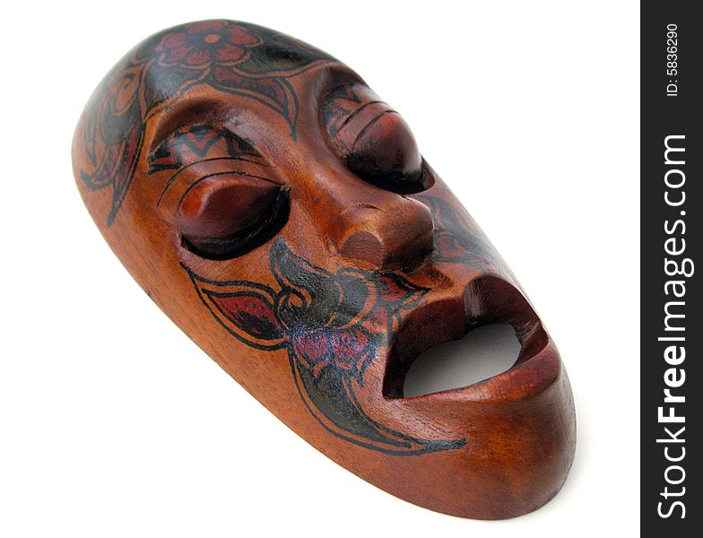 Carved wooden mask on white background