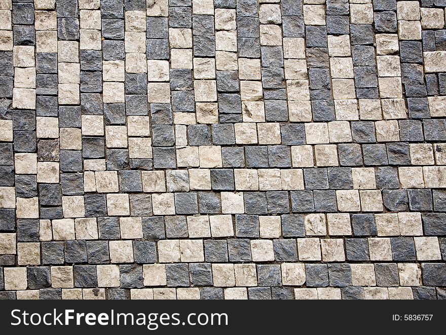 Stone design in Prague sidewalk. Background texture.