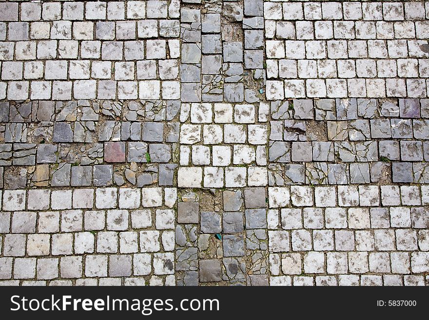 Stone design in Prague sidewalk. Background texture.