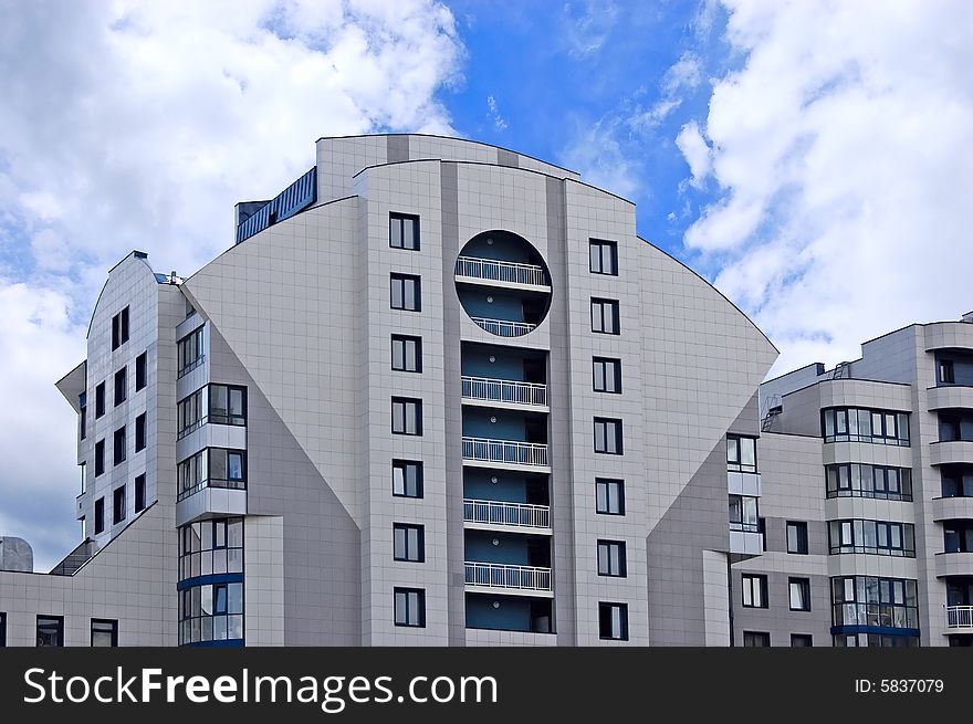 Modern office building on blue sky background