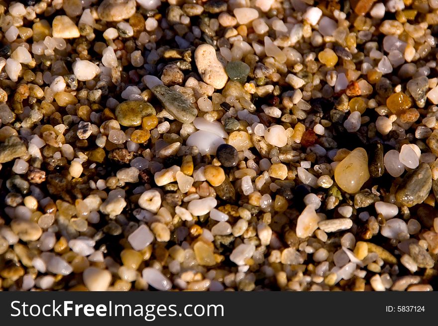 Small wet stones at the sea shore. Small wet stones at the sea shore