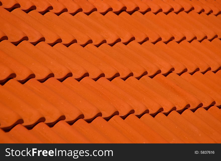Bright orange tiling roof in day-time