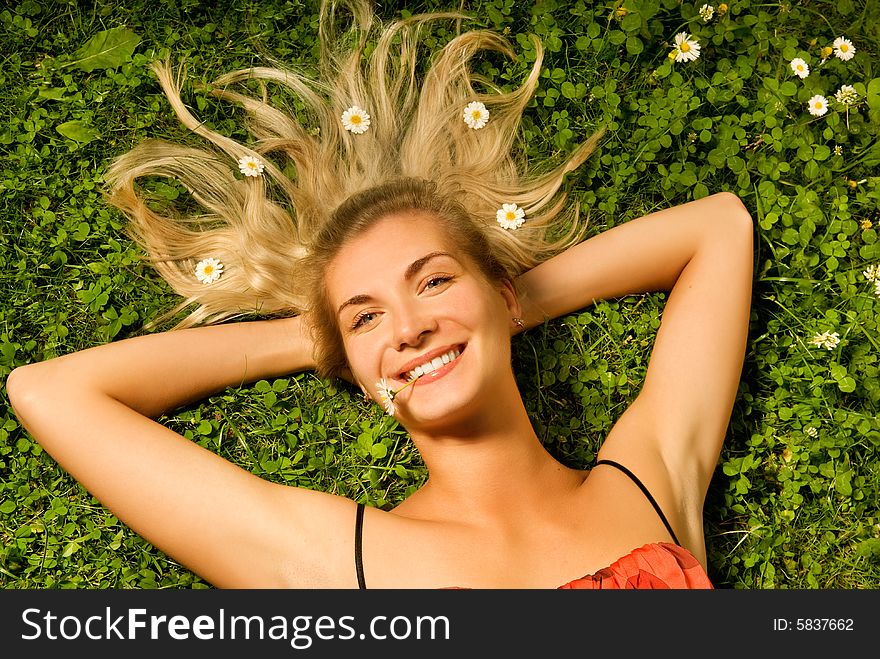 Girl Relaxing On A Meadow