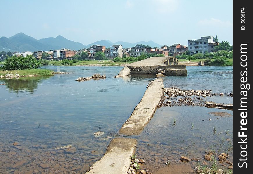 A broken bridge in the river by a town, Guilin City, Guangxi, China. A broken bridge in the river by a town, Guilin City, Guangxi, China