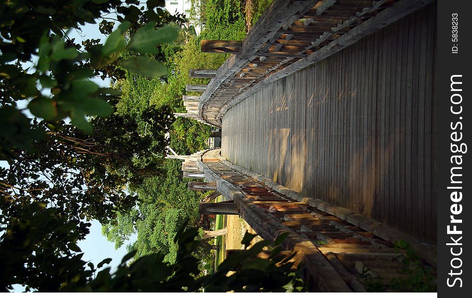 Wooden bridge over river in sunlight