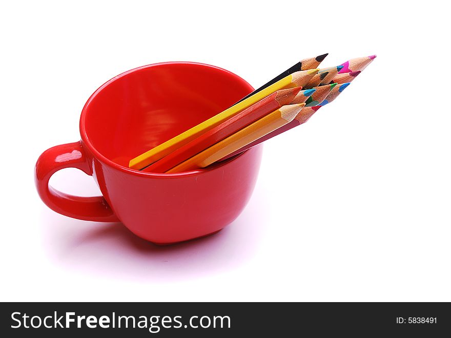 Colorful pencils in the red cup isolated on white background