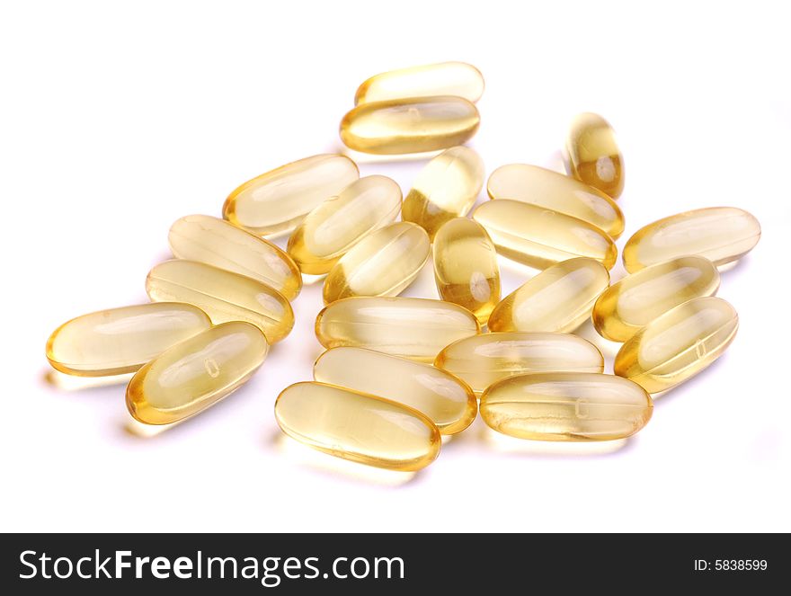 Pot of yellow pills isolated on white