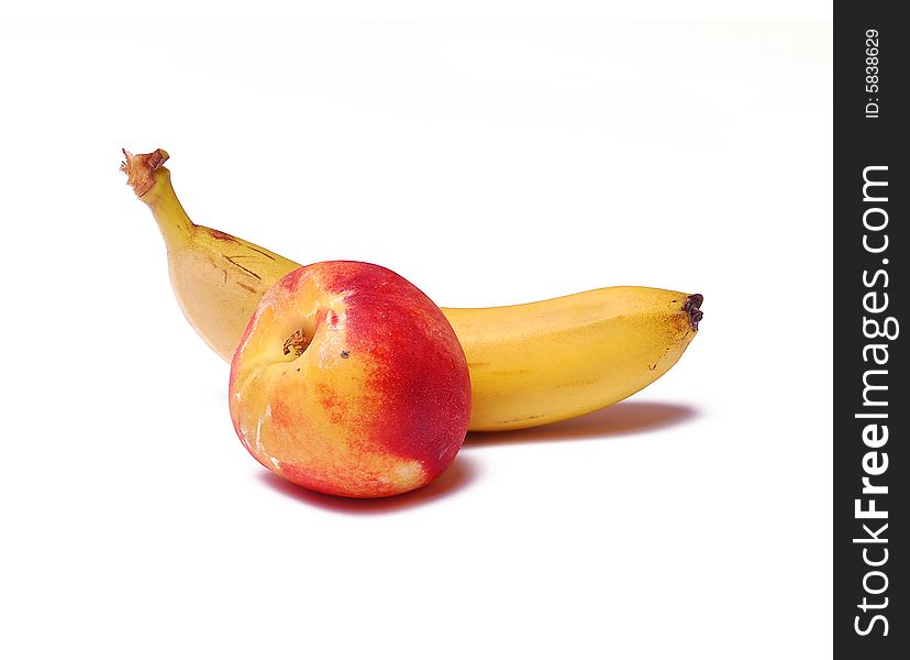 Banana and peach isolated on white background