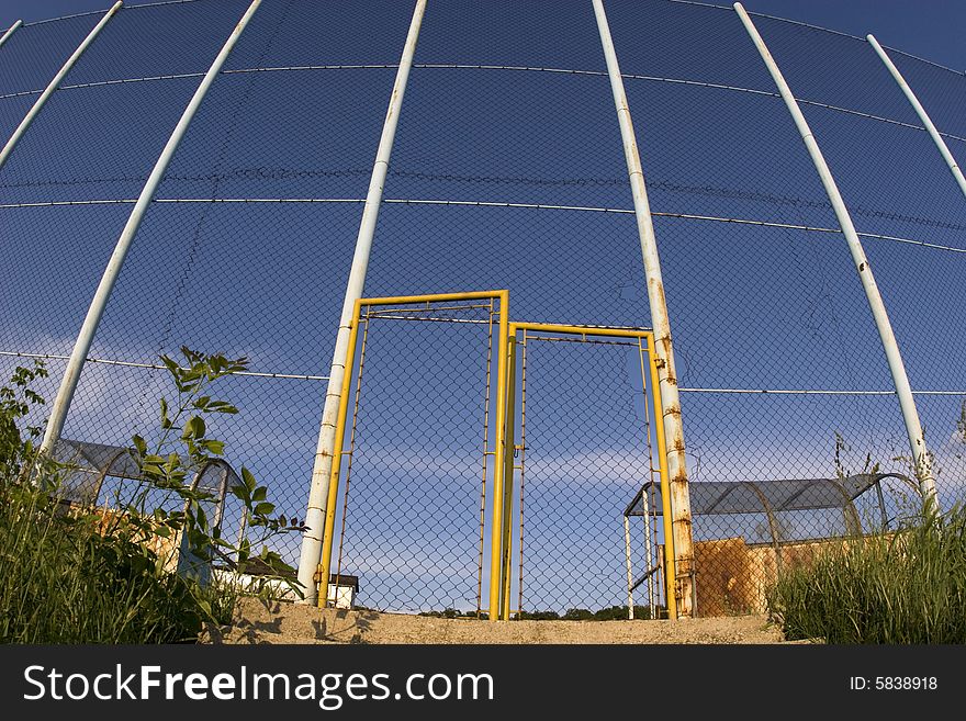 Wire fence and gate of local football  playground. Wire fence and gate of local football  playground.