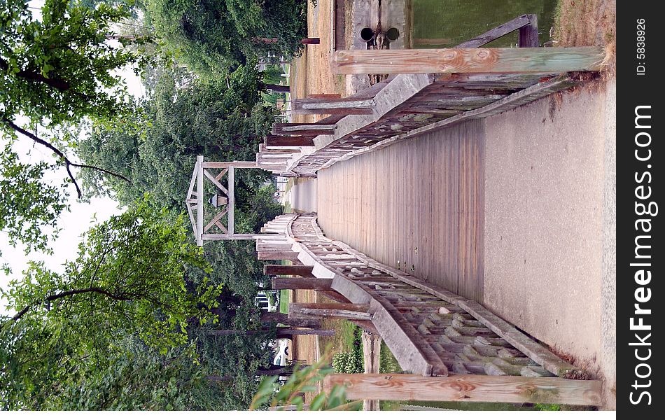 Wooden bridge over river in sunlight