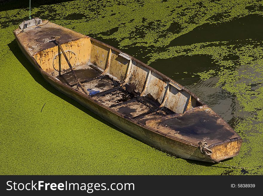 Old metal boat in green water field. Old metal boat in green water field