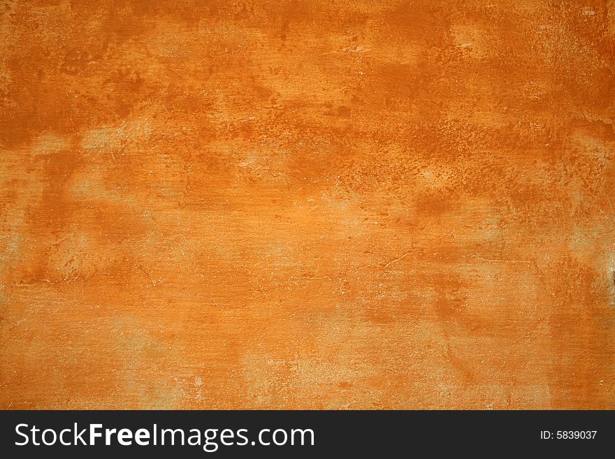A rough wall painted orange. A rough wall painted orange