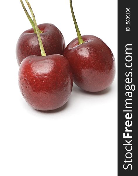 Three cherries with copy space on the bottom