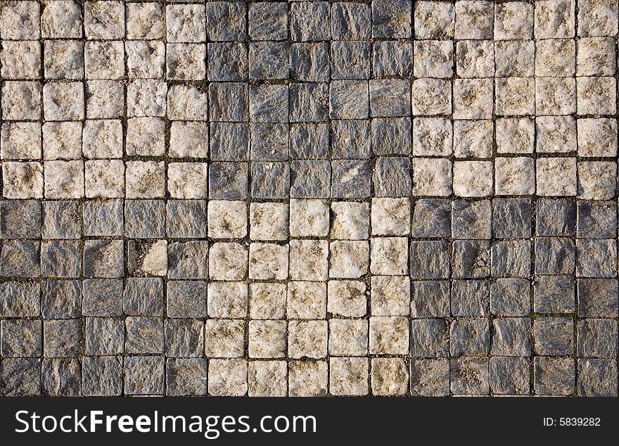 Stone design in Prague sidewalk. Background texture.