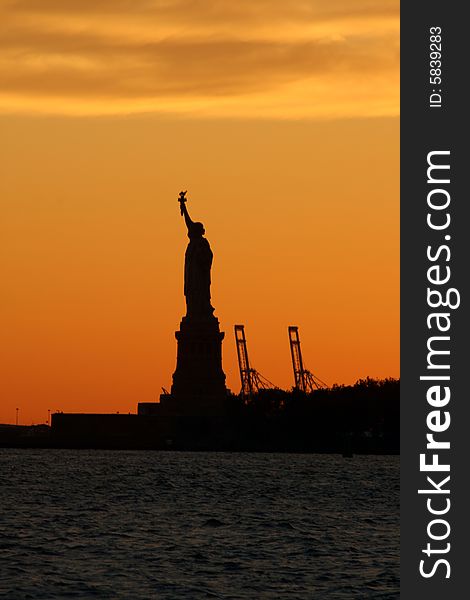 Dramatic Statue of Liberty at sunset in New York City