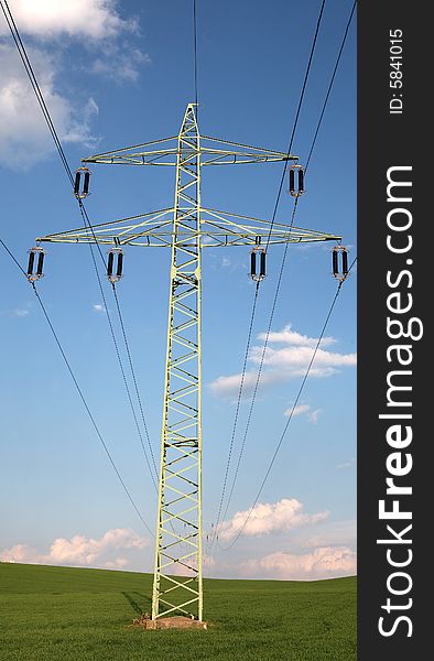 A transmission tower in a green field