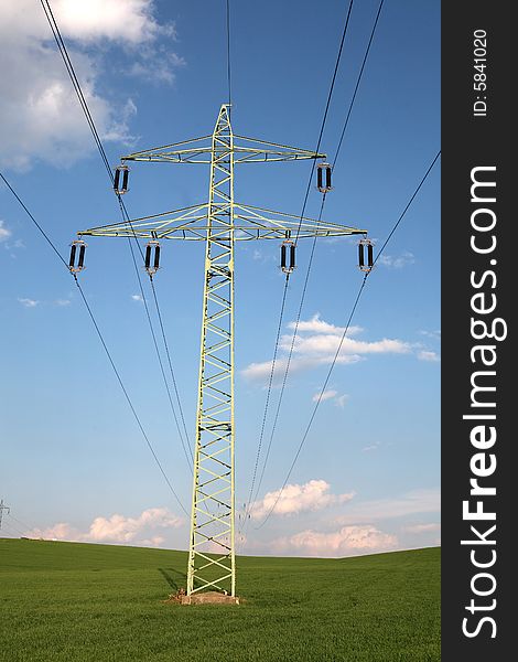 A transmission tower in a green field