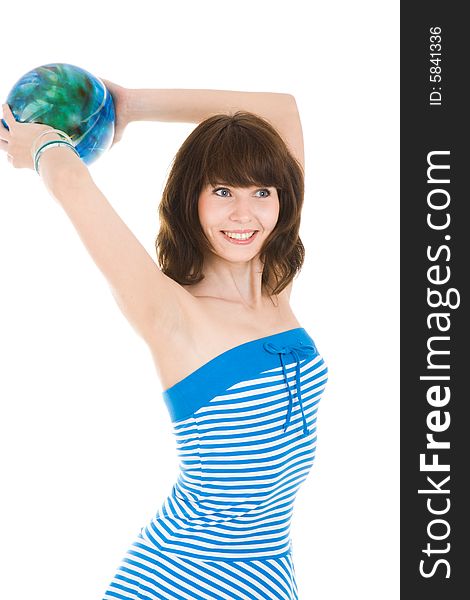 Smiling girl in the blue dress throwing ball
