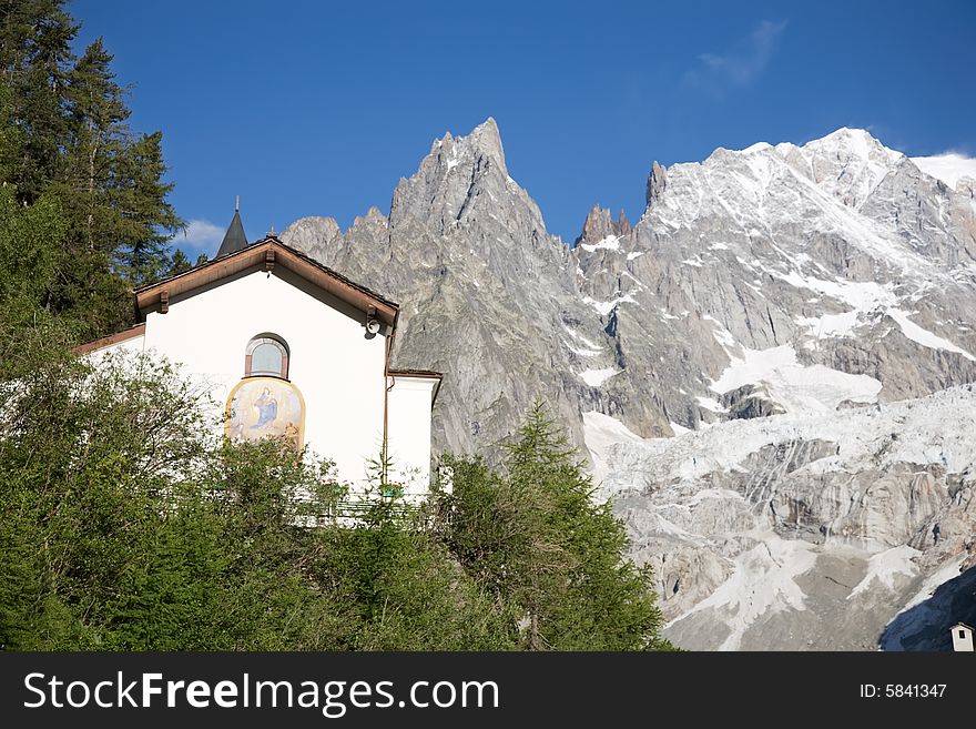 Small mountain church; in background the south side of Mont Blanc, Courmayeur, Italy.