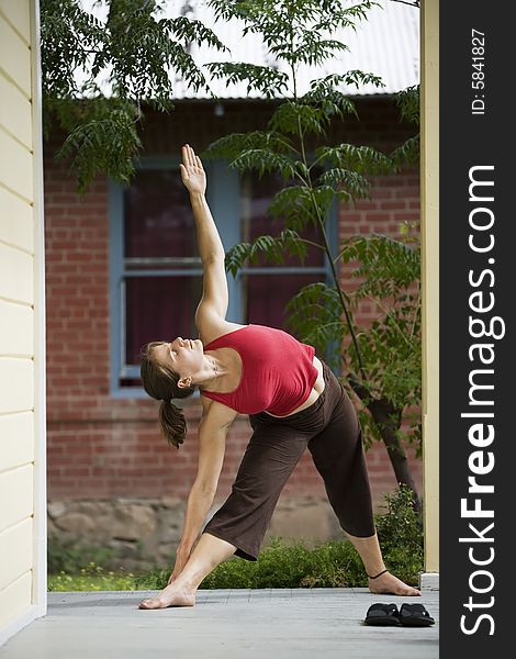 Pretty Young Woman doing Yoga on a Porch. Pretty Young Woman doing Yoga on a Porch