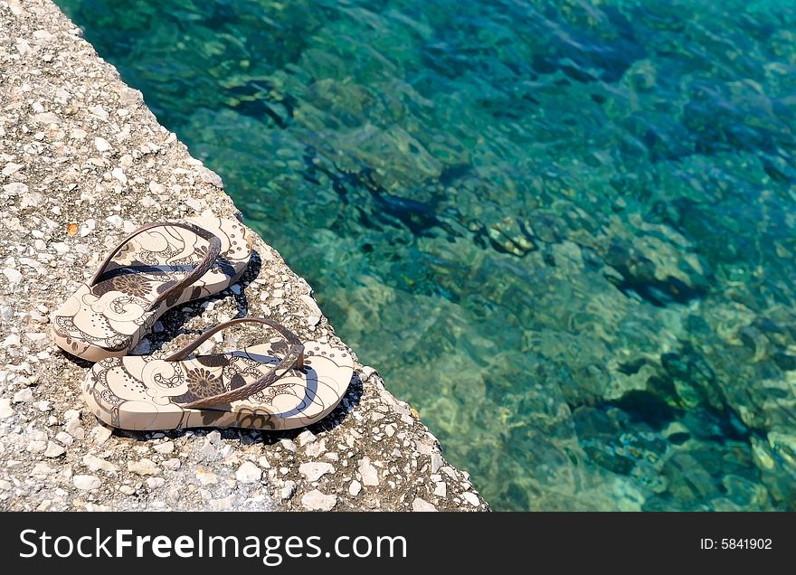 The pair of shoes by the sea