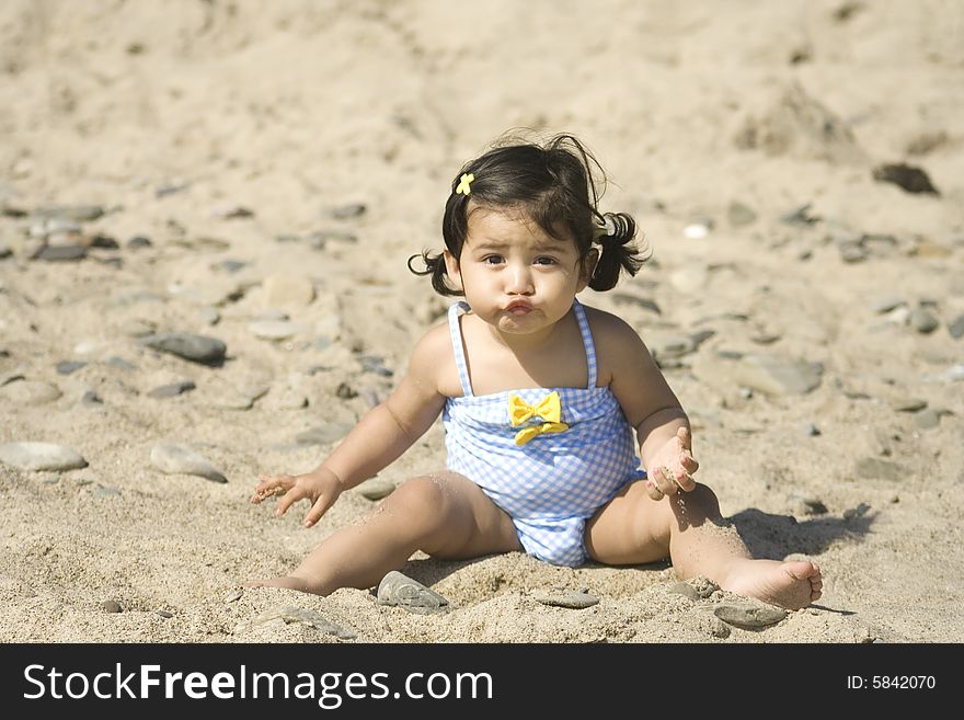 Girl making a funny face while playing at the beach. Girl making a funny face while playing at the beach.