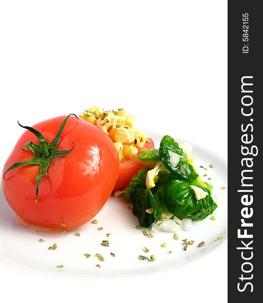 Tomato Stuffed with corn and 	
mayonnaise on a white dish