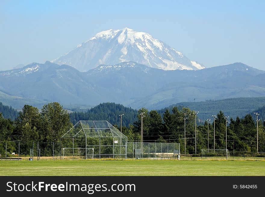 A majestic Mount Rainier towers over a soccer field in Washington State, USA. A majestic Mount Rainier towers over a soccer field in Washington State, USA.