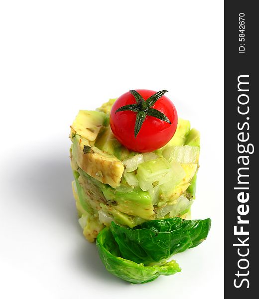 Guacamole tower with cherry tomato on white background